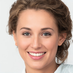 Joyful white young-adult female with medium  brown hair and green eyes