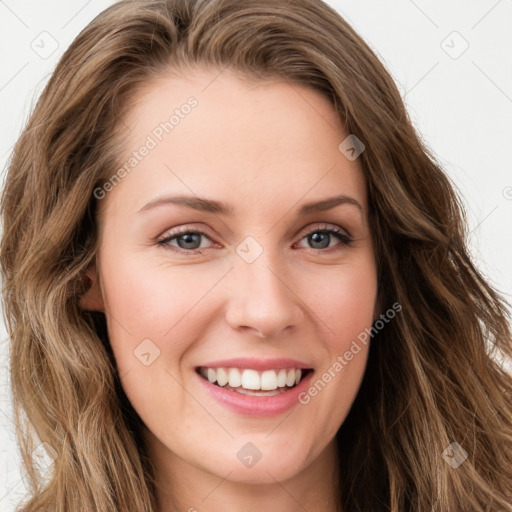 Joyful white young-adult female with long  brown hair and green eyes