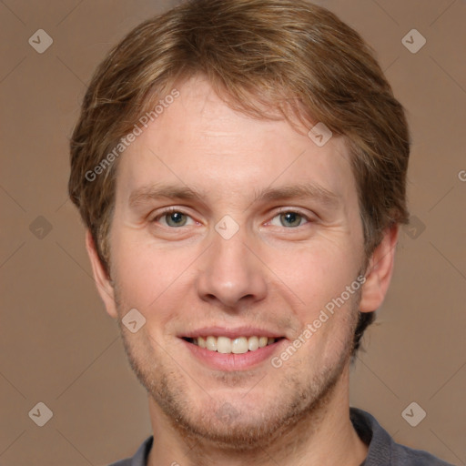 Joyful white adult male with short  brown hair and grey eyes