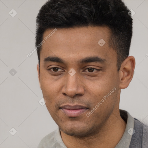 Joyful latino young-adult male with short  black hair and brown eyes