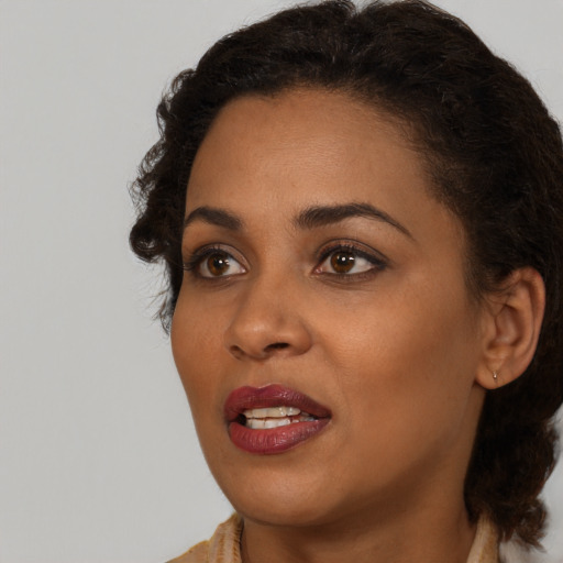 Joyful black young-adult female with medium  brown hair and brown eyes