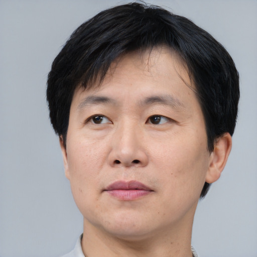 Neutral asian adult male with short  black hair and brown eyes