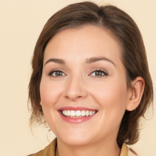 Joyful white young-adult female with medium  brown hair and brown eyes