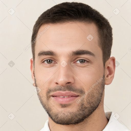 Joyful white young-adult male with short  brown hair and brown eyes