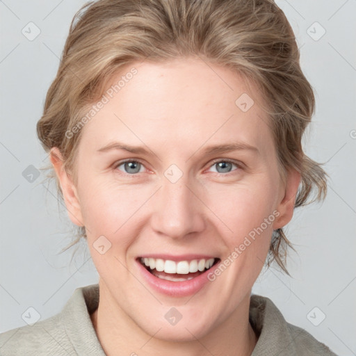 Joyful white young-adult female with medium  brown hair and blue eyes