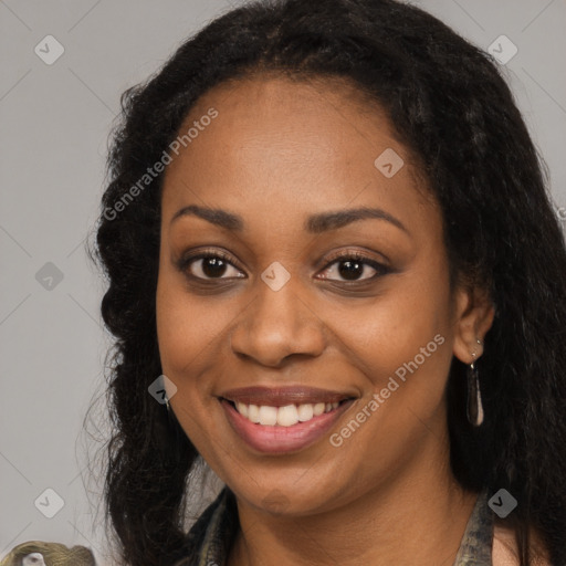 Joyful black young-adult female with long  brown hair and brown eyes