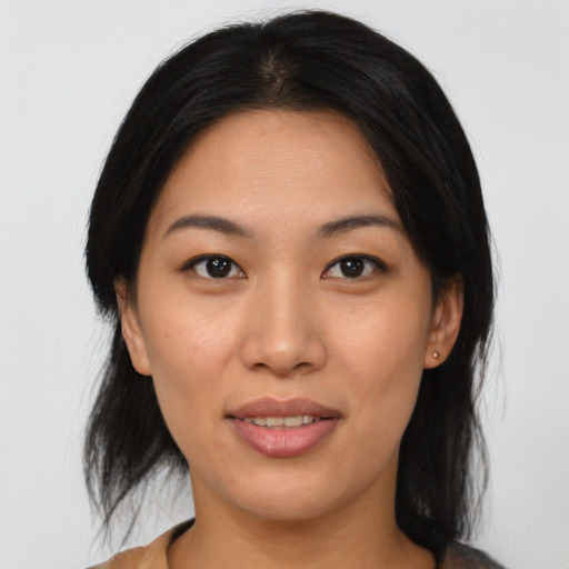 Joyful asian young-adult female with medium  brown hair and brown eyes