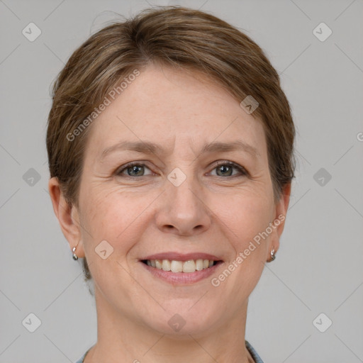 Joyful white adult female with short  brown hair and grey eyes