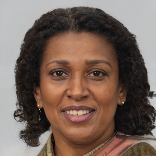 Joyful black adult female with medium  brown hair and brown eyes