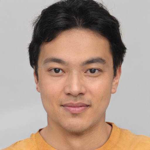 Joyful white young-adult male with short  black hair and brown eyes