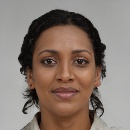 Joyful black young-adult female with medium  black hair and brown eyes