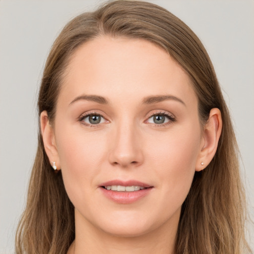 Joyful white young-adult female with long  brown hair and grey eyes