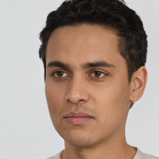 Neutral latino young-adult male with short  black hair and brown eyes
