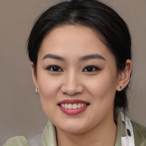 Joyful asian young-adult female with medium  brown hair and brown eyes