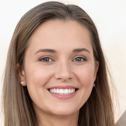 Joyful white young-adult female with long  brown hair and grey eyes