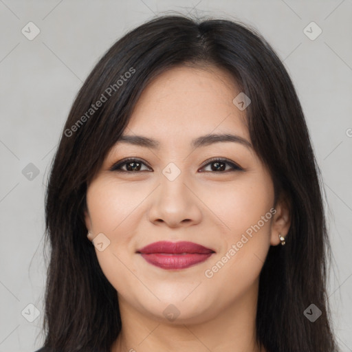 Joyful latino young-adult female with long  brown hair and brown eyes