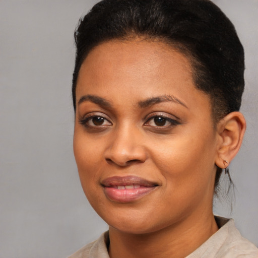 Joyful black young-adult female with medium  brown hair and brown eyes