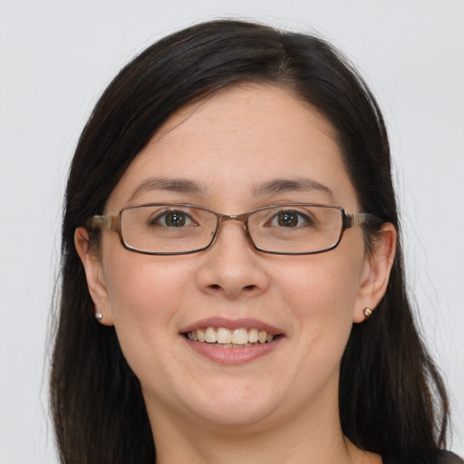 Joyful white adult female with long  brown hair and grey eyes