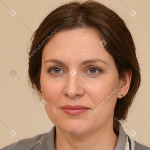 Joyful white adult female with medium  brown hair and grey eyes