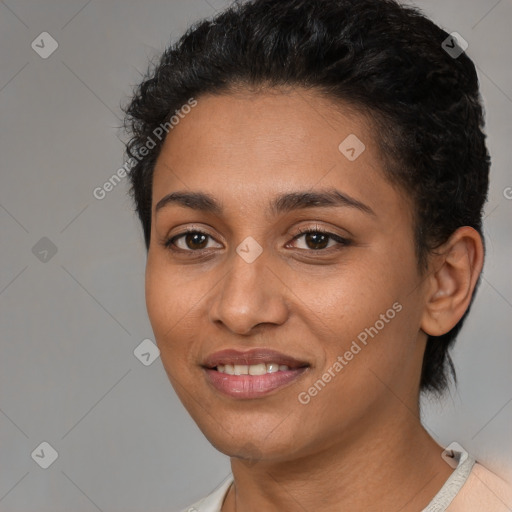 Joyful latino young-adult female with short  black hair and brown eyes