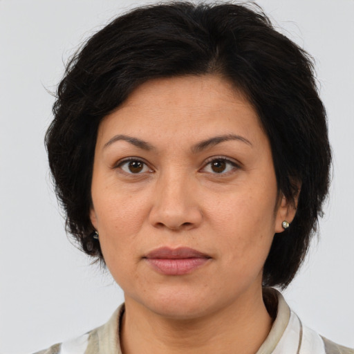Joyful asian adult female with medium  brown hair and brown eyes