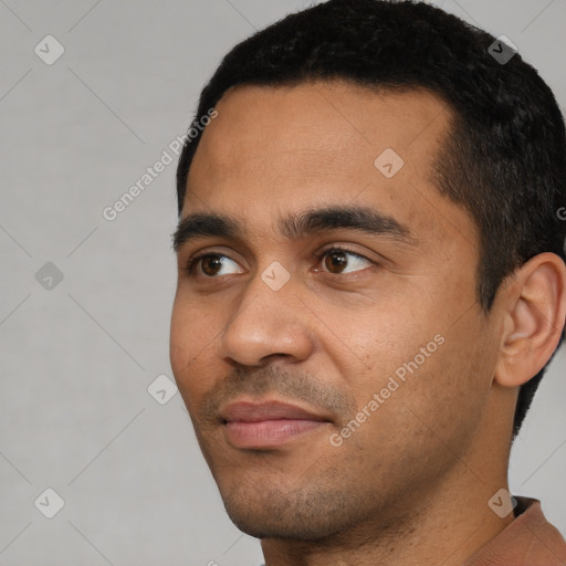 Joyful latino young-adult male with short  black hair and brown eyes