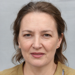 Joyful white adult female with medium  brown hair and grey eyes