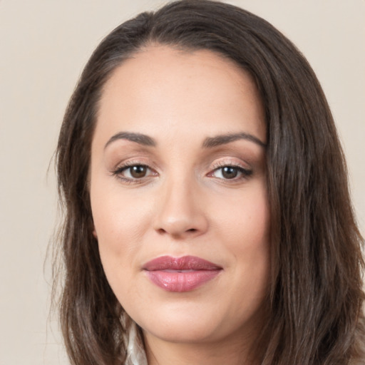 Joyful white young-adult female with long  brown hair and brown eyes