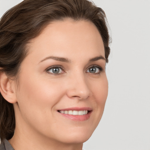 Joyful white young-adult female with medium  brown hair and grey eyes