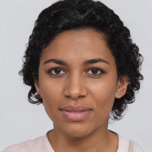 Joyful latino young-adult female with short  black hair and brown eyes