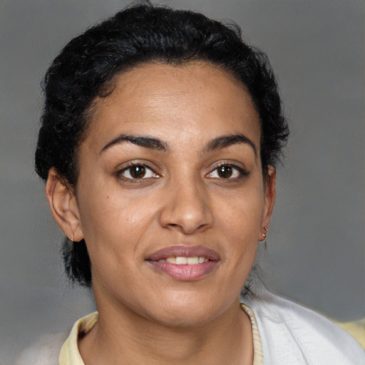 Joyful latino young-adult female with short  brown hair and brown eyes