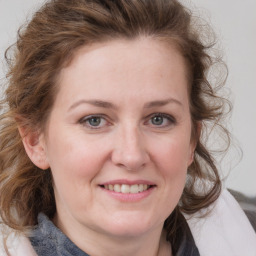 Joyful white young-adult female with medium  brown hair and blue eyes