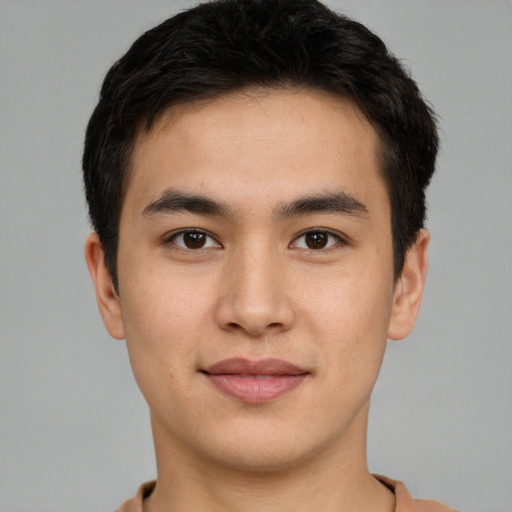 Joyful asian young-adult male with short  black hair and brown eyes