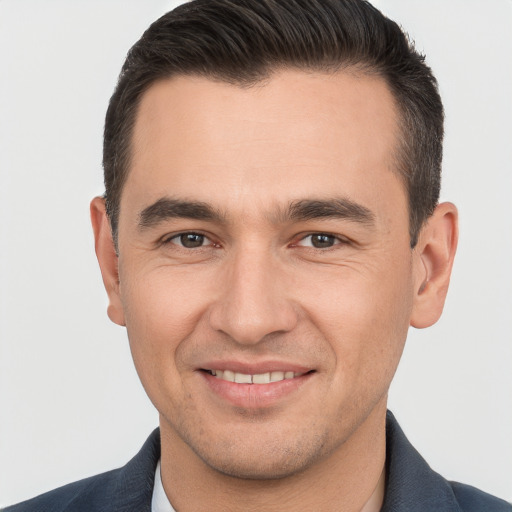 Joyful white young-adult male with short  brown hair and brown eyes