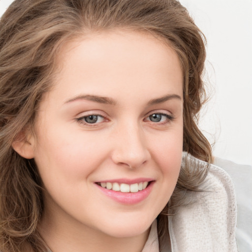 Joyful white young-adult female with long  brown hair and blue eyes