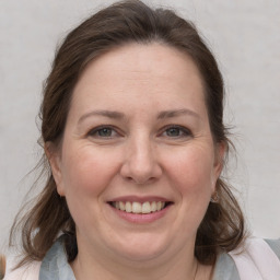 Joyful white adult female with medium  brown hair and grey eyes