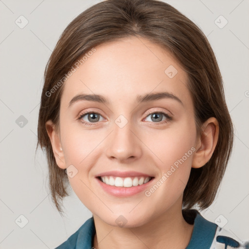 Joyful white young-adult female with medium  brown hair and grey eyes