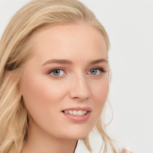 Joyful white young-adult female with long  blond hair and blue eyes