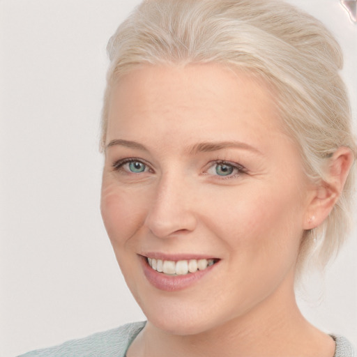 Joyful white young-adult female with medium  blond hair and blue eyes