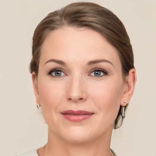 Joyful white young-adult female with medium  brown hair and grey eyes