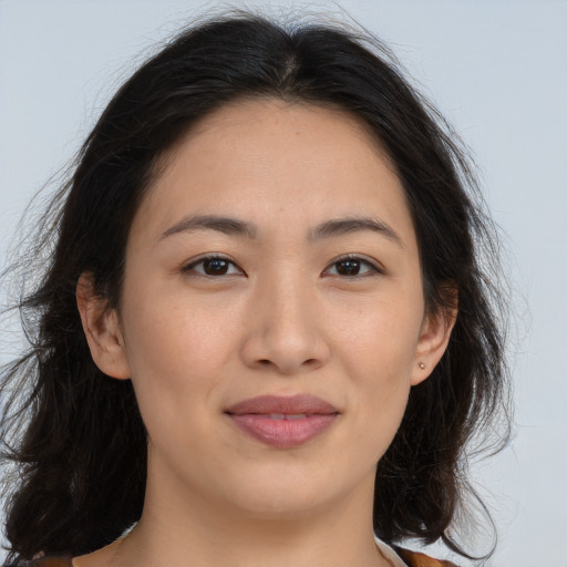 Joyful asian young-adult female with long  brown hair and brown eyes