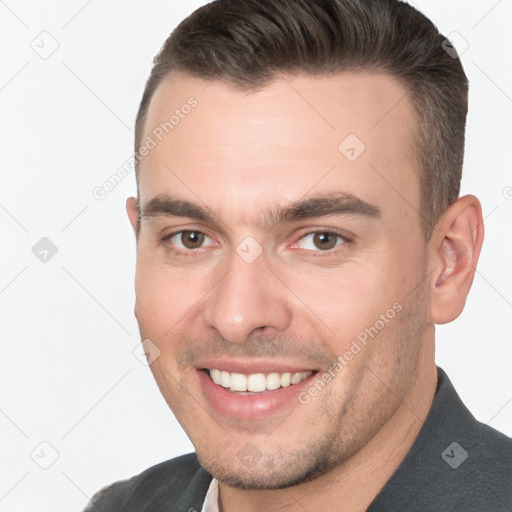 Joyful white young-adult male with short  brown hair and brown eyes