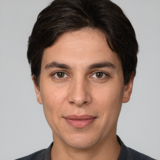 Joyful white adult male with short  brown hair and brown eyes