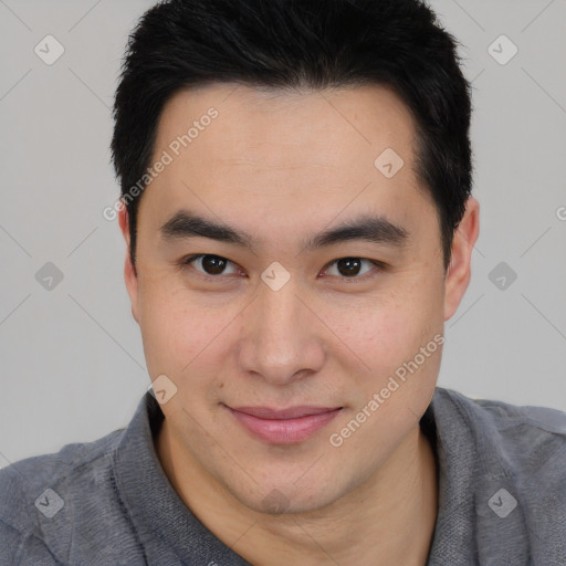 Joyful asian young-adult male with short  brown hair and brown eyes