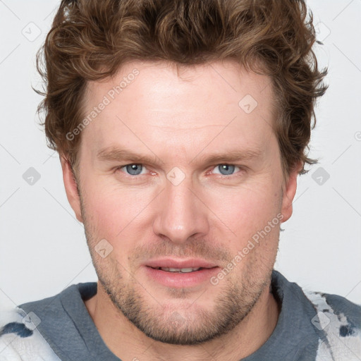 Joyful white adult male with short  brown hair and blue eyes