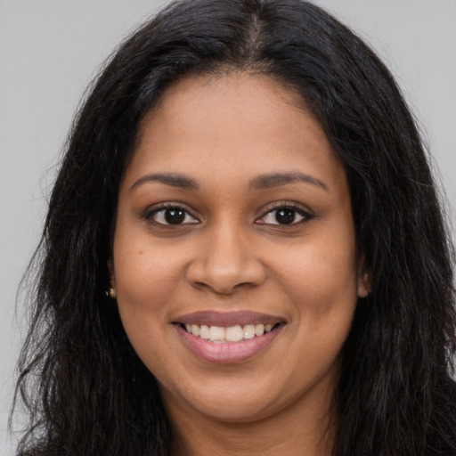 Joyful latino young-adult female with long  brown hair and brown eyes