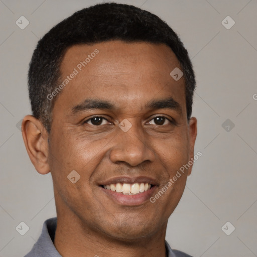 Joyful black young-adult male with short  black hair and brown eyes