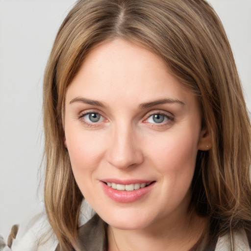 Joyful white young-adult female with long  brown hair and grey eyes