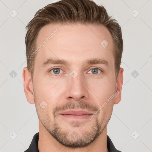 Joyful white young-adult male with short  brown hair and grey eyes