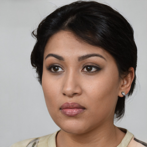 Neutral latino young-adult female with medium  brown hair and brown eyes